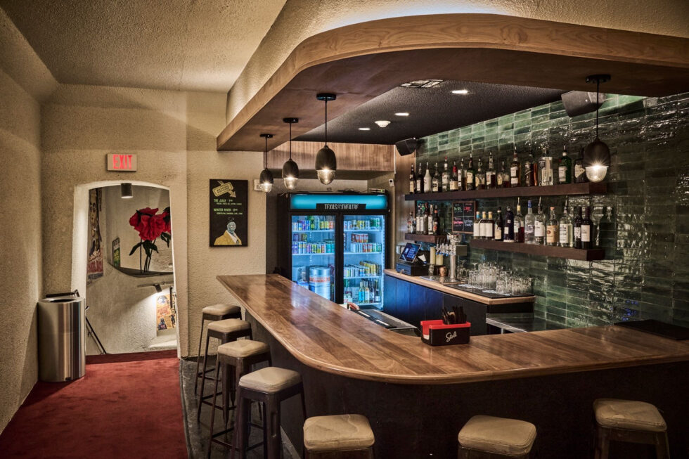 New upstairs bar with green tile backsplash and modern wood bar